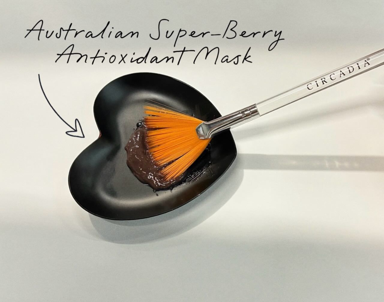 Fan brush in a heart-shaped mask bowl